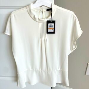 Brand new DKNY off white peplum blouse with pleated neck line. 🤍